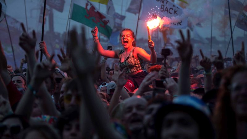 TOPSHOT - Revellers watch as British singer Liam Gallagher performs on the Pyramid Stage at the Glastonbury Festival of Music and Performing Arts on Worthy Farm near the village of Pilton in Somerset, South West England, on June 29, 2019. (Photo by Oli SCARFF / AFP)