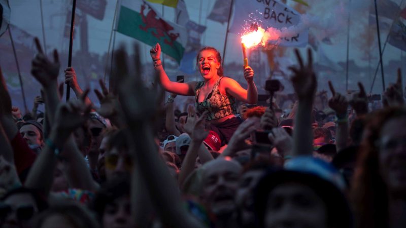 TOPSHOT – Revellers watch as British singer Liam Gallagher performs on the Pyramid Stage at the Glastonbury Festival of Music and Performing Arts on Worthy Farm near the village of Pilton in Somerset, South West England, on June 29, 2019. (Photo by Oli SCARFF / AFP)