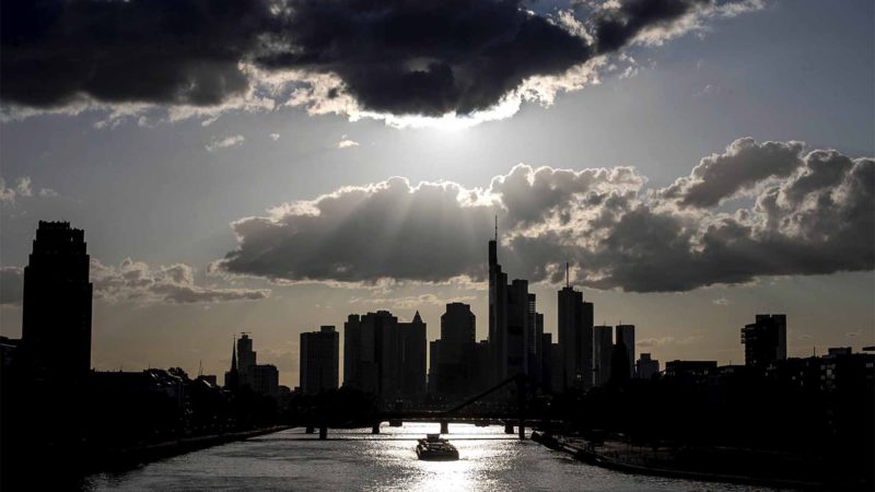 A cargo ship passes the buildings of the banking district in Frankfurt, Germany, Saturday, Aug. 10, 2019. (AP Photo/Michael Probst)