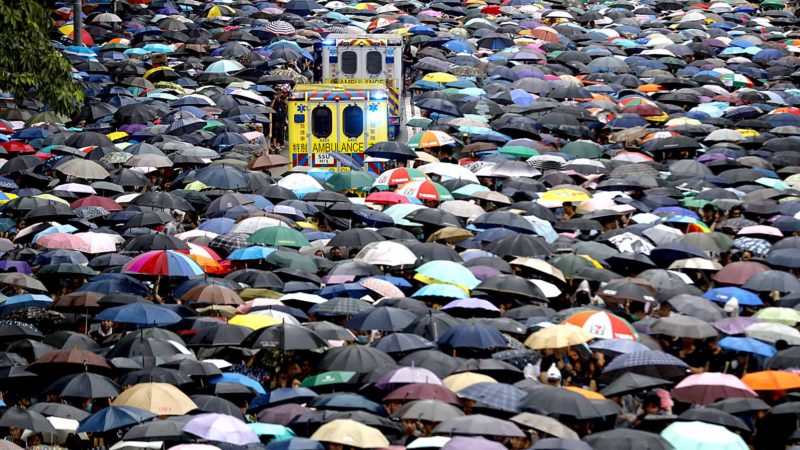 Protesters make space for ambulances to travel during a rally in Hong Kong Sunday, Aug. 18, 2019. Heavy rain fell on tens of thousands of umbrella-ready protesters as they started marching from a packed park in central Hong Kong, where mass pro-democracy demonstrations have become a regular weekend activity. (AP Photo/Vincent Thian)