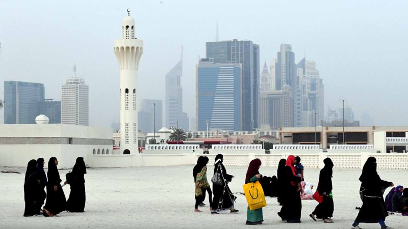 Backdropped by Dubai's trademark skyscrapers, Muslim women walk past a minaret as they leave after performing morning prayers to mark the Eid al-Adha at Dubai's main mosque and outdoor prayer grounds on August 11, 2019. - Muslims across the globe celebrated the first day of the Feast of Sacrifice which commemorates Abraham's willingness to sacrifice his son for God and marks the end of the  annual Hajj pilgrimage to Mecca. (Photo by Karim SAHIB / AFP)