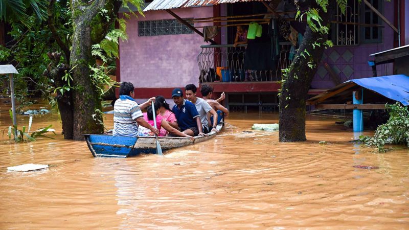 Residents use a boat as floodwaters submerged areas of Ye township in Mon State on August 11, 2019. - Myanmar troops deployed to flood-hit parts of the country on August 11 to help with relief efforts after rising waters left thousands stranded and the death toll from a landslide jumped to 51. (Photo by Ye Aung THU / AFP)