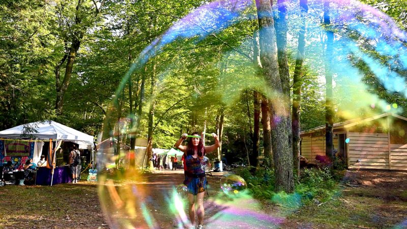 A woman makes bubbles during the Yasgur Road Reunion- 50th Woodstock Anniversary Celebration on August 16, 2019 in Bethel, New York. (Photo by Angela Weiss / AFP)