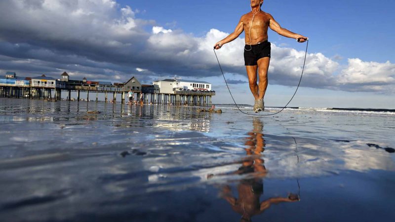 Fitness enthusiast Johnny C., 63, of Old Orchard Beach, Maine, jumps rope on the wet sand in his hometown, Thursday, Aug. 29, 2019. The popular summer tourist destination is gearing up the big Labor Day weekend. AP/RSS. 