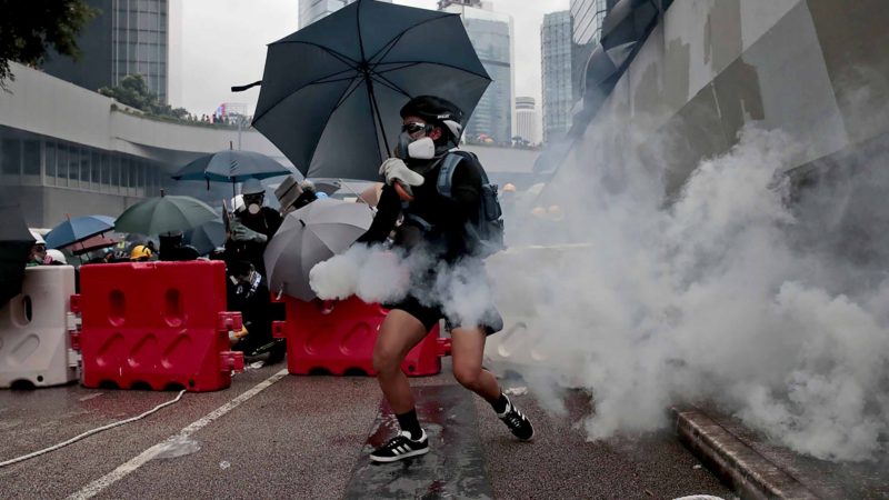 A protestor holds an exploded tear gas shell in central Hong Kong, Saturday, Aug. 31, 2019. The mostly young, black-shirted protesters took over roads and major intersections in shopping districts as they rallied and marched. Police erected additional barriers and brought out two water cannon trucks near the Chinese government office and deployed at various locations in riot gear. (AP Photo/Jae C. Hong)