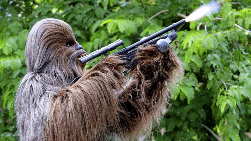 Chewbacca fires a weapon to mark the dedication moment during a ceremony with invited guests at the entrance of the Star Wars: Galaxy's Edge attraction at Disney's Hollywood Studios in Lake Buena Vista, Fla., Wednesday, Aug. 28, 2019. The Star Wars-themed land at Disney World officially opens to guests on Thursday.  AP/RSS.