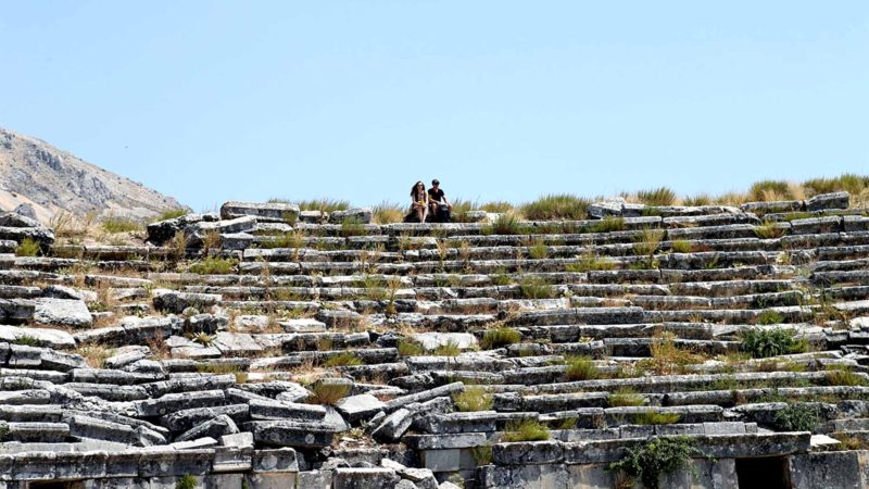 ANKARA-- Visitors sit in the ancient city of Sagalassos, near the town of Aglasun in Burdur province, Turkey, on Aug. 21, 2019. The archaeological site of Sagalassos is located in southwest Turkey. The ancient city was founded on the south facing slopes of the Taurus mountain range. The first traces of hunter/gatherers in the territory of Sagalassos date back to some 12,000 years BP, according to the UNESCO. Xinhua/RSS.