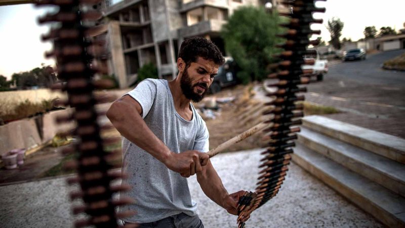 (190818) -- TRIPOLI, Aug. 18, 2019 (Xinhua) -- A fighter of the UN-backed Government of National Accord (GNA) prepares weapons and ammunition in the base near Salah Al-Din frontline in Tripoli, Libya, on Aug. 17, 2019. Since early April, the government has been engaged in a deadly armed conflict against the army, which is trying to take over the capital Tripoli and overthrow the government. 
 The fighting so far has killed more than 1,000 people, injured more than 5,700 others, and forced over 120,000 to flee their homes, according to the World Health Organization. (Photo by Amru Salahuddien/Xinhua)