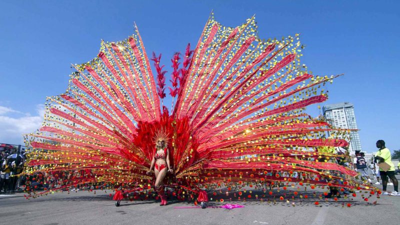 (190804) -- TORONTO, Aug. 4, 2019 (Xinhua) -- A dressed up reveller poses for photos with her float during the 2019 Toronto Caribbean Carnival Grand Parade in Toronto, Canada, Aug. 3, 2019. People from near and far converged on the street for the annual Caribbean Carnival Grand Parade here on Saturday. (Xinhua/Zou Zheng)