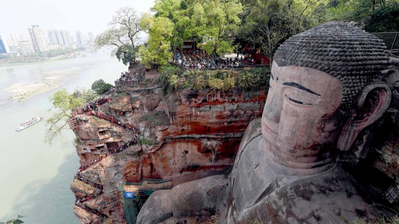 (190802) -- BEIJING, Aug. 2, 2019 (Xinhua) -- Tourists view the statue of the Leshan Giant Buddha in Leshan City, southwest China's Sichuan Province, April 1, 2019. Located in southwest China, Sichuan is a landlocked province boasting various biological resources and landscapes.
 Sichuan is often dubbed as "giant panda capital of the world," as more than 70% wild pandas live in the province. To bring the species back from the brink of extinction, relevant authorities have been implementing measures to protect and restore habitats, as well as expand and build nature reserves and breeding bases, in a race to save the bear. 
 As a key ecological barrier and water reserve, Sichuan has many visages from fairyland-like grassland, lush greenery canyons to crystal-clear lakes. Jiuzhai Valley (Jiuzhaigou National Park), located in the mountains on the eastern edge of the Qinghai-Tibet Plateau, is well-known for its ethnic minority communities, superb mountains and stunning scenery.
 During the past years, following the green development principle, Sichuan authorities adopt various measures to protect the environment including enhancing natural resources management and improving afforestation. 
 From 1 to 3 in August, the "Sichuan Day" event is held at the ongoing Beijing International Horticultural Exhibition. Visitors can take a glimpse of the beauty of home to giant pandas. (Xinhua/Jiang Hongjing)