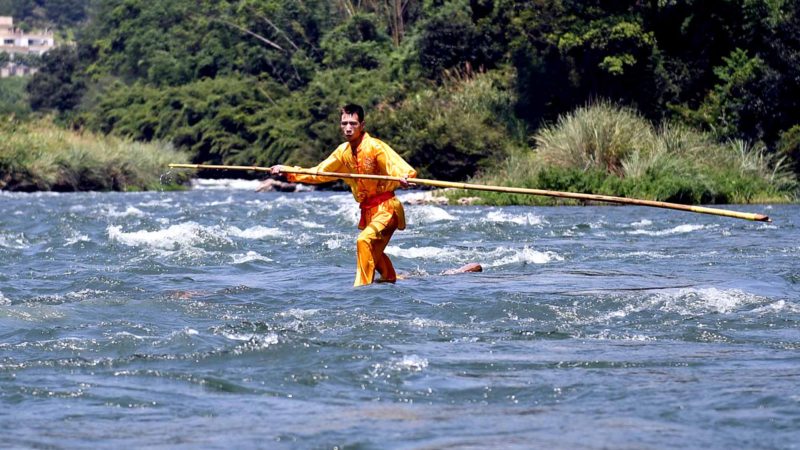 (190820) -- BEIJING, Aug. 20, 2019 (Xinhua) -- Xie Ziben, a villager from Juzhou Village, performs single bamboo drifting at Dadaotou Village of Hongkou Town in Ningde City, southeast China's Fujian Province, Aug. 18, 2019. Single bamboo drifting, also known as "Zhanmu", dates back to over 600 years ago. It was once used to transport logs by locals, but nowadays has become a traditional performance to attract visitors. (Xinhua/Lin Shanchuan)