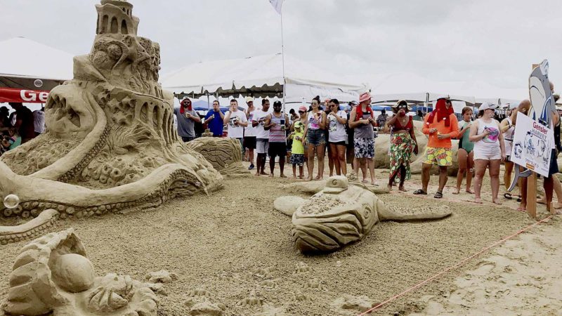 GALVESTON -- Spectators look at the sandcastle "Deep Blue" at the AIA Sandcastle Competition in Galveston, the United States, Aug. 24, 2019. Xinhua/RSS.