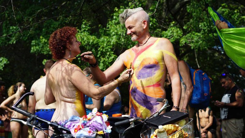 In this photo provided by David Cimetta, Melanie and Jim OâConnor paint each other's nude body while standing next to their bicycles before the start of the Philly Naked Bike Ride in Philadelphia on Saturday Aug. 24, 2019. AP/RSS.