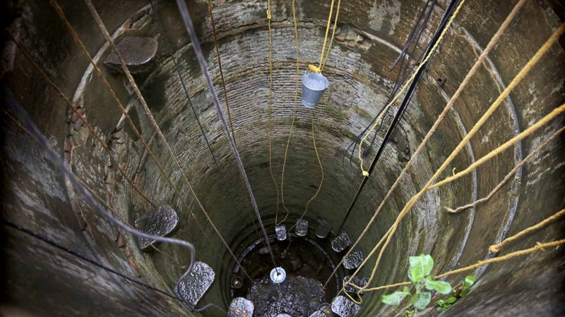 In this Tuesday, July 16, 2019, photo, buckets are lowered down into an almost-dried well on the outskirts of Chennai, capital of the southern Indian state of Tamil Nadu. Rapid development and rampant construction in the coastal city of about 10 million have overtaxed a once-abundant natural water supply, forcing the government to expend huge sums to desalinate sea water, bring water by train from hundreds of miles away and deploy an army of water trucks to people whose household taps have suddenly run dry. (AP Photo/Manish Swarup)