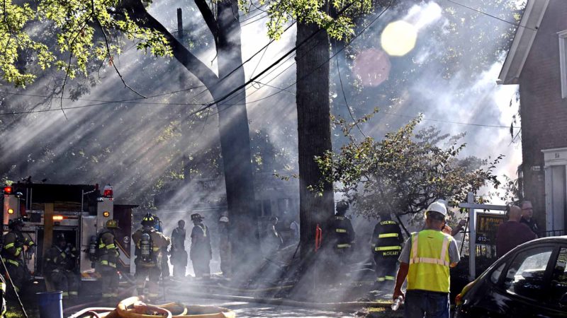 First responders work at the scene of a house fire in Edgewood, Pa,. on Saturday, Sept. 14, 2019. Flames were reported at two homes Saturday afternoon in suburban Edgewood. Emergency officials say one house collapsed and another next door was damaged.  (Christian Snyder/Pittsburgh Post-Gazette via AP)