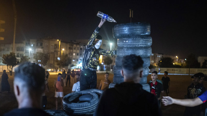 In this Monday, Sept. 9, 2019 photo, a youth pours kerosene over tires to light a bonfire in celebration of Ashura, in Sale, near Rabat, Morocco. On Sept. 9, the Arab and Muslim world marked Ashura, a day commemorating the death of Imam Hussein, the grandson of the Prophet Muhammad and one of Shia Islam's most important figures. (AP Photo/Mosa'ab Elshamy)