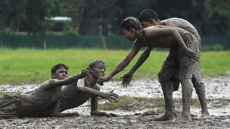 Children play a game of Kabaddi on water logged grounds in Kolkata on September 8, 2019.  Photo RSS