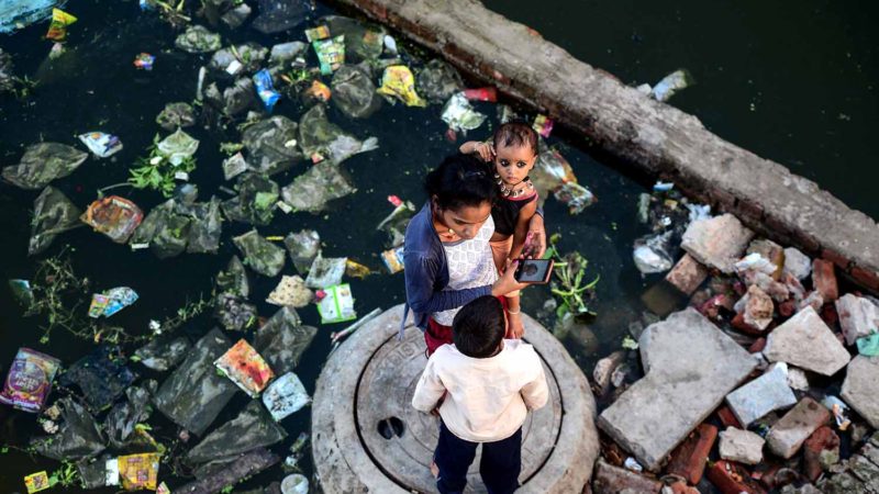 Residents stand outside their flooded residence in the Ganga Nagar area of Allahabad as the water level of the Ganges and Yamuna rivers rise on September 15, 2019. Photo/RSS