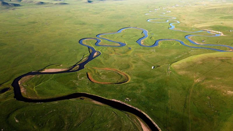 (190903) -- HULUNBUIR, Sept. 3, 2019 (Xinhua) -- Aerial photo taken on Aug. 29, 2019 shows a river passing through Hulunbuir, north China's Inner Mongolia Autonomous Region. Located in the northeastern Inner Mongolia Autonomous Region, Hulunbuir, named after the Hulun Nur and Buir Nur, covers an area of about 253,000 square kilometers. It is home to more than 40 ethnic groups, including Han, Mongolian, Daur, Ewenki, Oroqen and Russian, etc. It boasts beautiful grasslands and vast forests, among which more than 500 lakes, over 3,000 rivers and large scale wetlands dot. The grassland, clear water, blue sky, white clouds, cattle and sheep have made Hulunbuir a famous tourist destination. (Xinhua/Ren Junchuan)