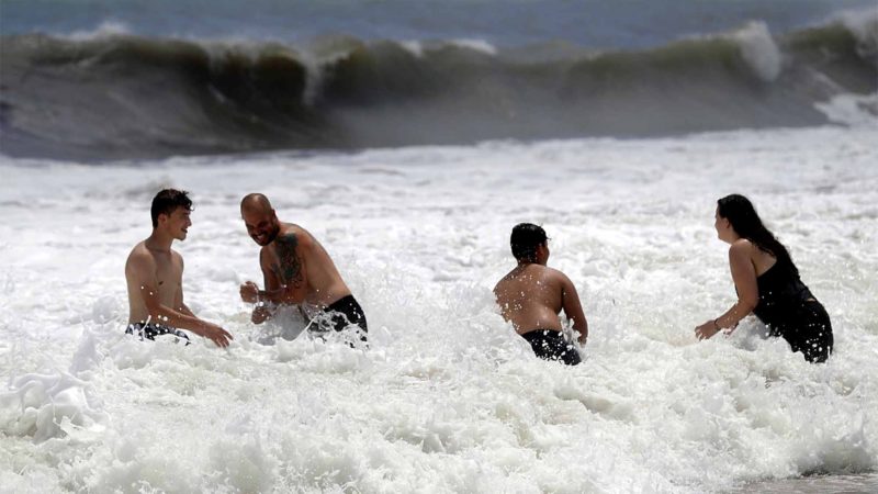 People play in the high surf from the Atlantic Ocean on the barrier island in Vero Beach, Fla., Sunday, Sept. 1, 2019. The barrier island is under a voluntary evacuation today and a mandatory evacuation tomorrow in preparation for the possibility of Hurricane Dorian making landfall. (AP Photo/Gerald Herbert)