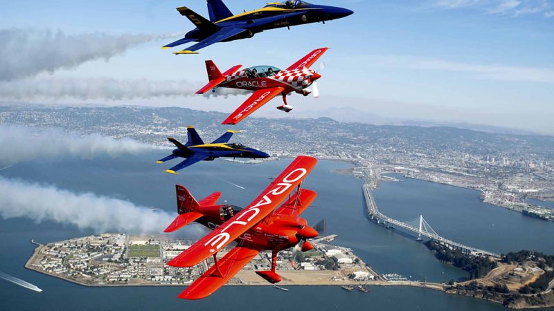 In advance of Fleet Week performances, U.S. Navy Blue Angels fly above San Francisco with Team Oracle aerobatics pilots Sean D. Tucker and Jessy Panzer on Thursday, Oct. 10, 2019. (AP Photo/Noah Berger)