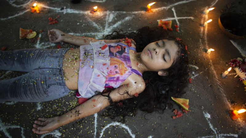 Girl lies surrounded by candles and designs of white powder during a ceremony on Sorte Mountain where followers of indigenous goddess Maria Lionza gather annually in Venezuela's Yaracuy state. Believers congregated for rituals on the remote mountainside where adherents make an annual pilgrimage to pay homage to the goddess, seeking spiritual connection and physical healing. AP Photo/RSS