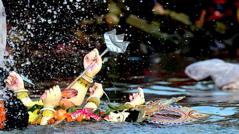  Hindu devotees submerge a clay idol of the Hindu goddess Durga on the final day of the Durga Puja festival in Dhaka on October 8, 2019. (Photo by MUNIR UZ ZAMAN / AFP) / RSS.l