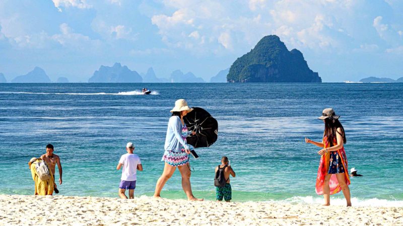 (FILES) In this file photo taken on October 04, 2019, tourists visit Khai island in the Andaman Sea. - Hotels in Thailand's most popular holiday island have been forced to slash prices with rooms left vacant and beaches sparse as tourist chiefs struggle with a plunge in visitors from China caused by the US trade war and stronger baht. (Photo by Mladen ANTONOV / AFP)