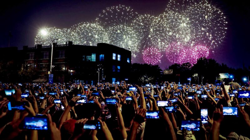 People use smartphones to film fireworks exploding at Tiananmen Square as part of a gala evening commemorating the 70th anniversary of the founding of Communist China light up the sky in Beijing, Tuesday, Oct. 1, 2019. China's Communist Party marked 70 years in power with a military parade Tuesday that showcased the country's global ambitions while police in Hong Kong fought protesters in a reminder of strains at home. AP/RSS