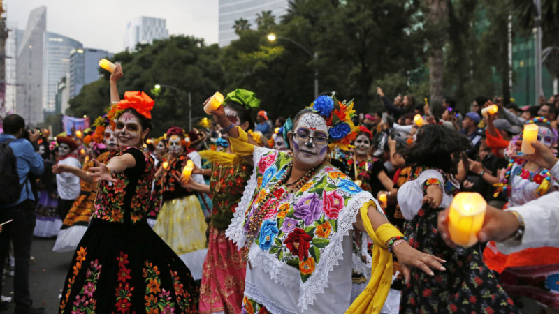 People dressed as Catrinas parade down Mexico City's iconic Reforma avenue during celebrations for the Day of the Dead in Mexico, City, Saturday, Oct. 26, 2019. (AP Photo/Ginnette Riquelme)