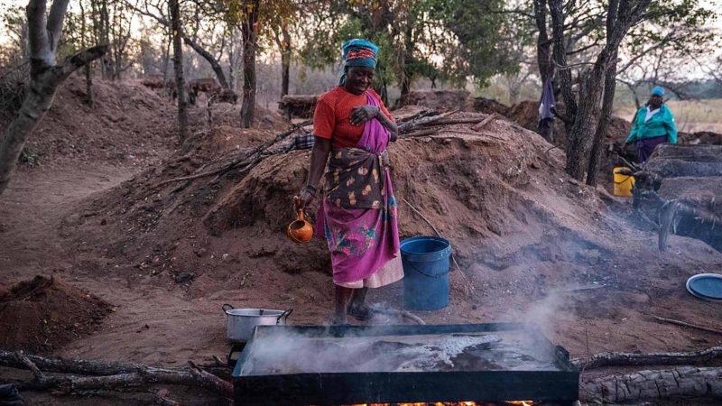 Ndaheni Mashele, 66, oversees salt-rich water boiling on the bank of the Klein Letaba River near Baleni, in the South African province of Limpopo, on August 26, 2019. - The Baleni salt is sacred to locals in the remote northern region of South Africa where it is mined from a spring. 
Harvested traditionally in the dry season from the Klein Letaba river in Limpopo province, the Baleni crystals are tiny, evenly-sized and chunky with a very salty taste. (Photo by Michele Spatari / AFP)