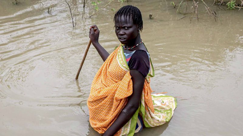 A South Sudanese woman walk in a flooded area that has been isolated for about a month and half due to the heavy rain in Pibor Town, Boma state, eastern South Sudan, on November 6, 2019. - The governor of Boma State explained 76 people have died and over 400000 people are displaced in the state. The Government of South Sudan declared a state of emergency in areas affected by the flood on October 27, 2019, and the United Nations and non-governmental organizations are responding to assessed needs, in support of the Government. (Photo by Peter LOUIS / AFP)