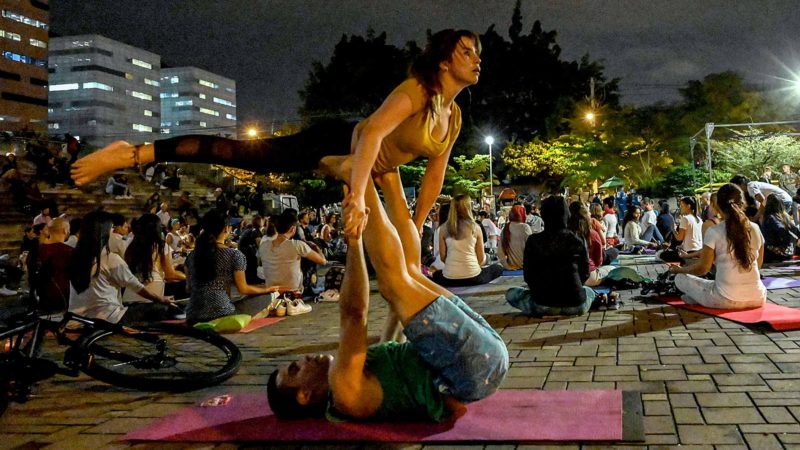People take part in a yoga session in support of a strike against the government of Colombian President Ivan Duque, in Medellin, Colombia, on November 29, 2019, the eighth consecutive day of protests. - Since last Thursday Colombia has been hit by unprecedented mass protests against the unpopular Duque, joining a wave of grassroots anger that, for different reasons, has swept through Ecuador, Chile and Bolivia. (Photo by JOAQUIN SARMIENTO / AFP)