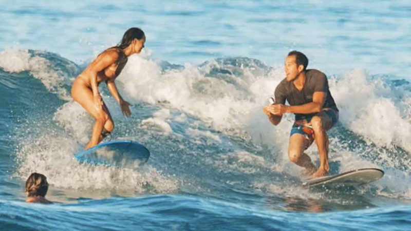 In this Sunday, Nov. 10, 2019 photo, instead of just hanging ten when surfing with his girlfriend, Chris Garth drops to one knee and proposes to Lauren Oiye in the surf off Queen's Beach in Waikiki in Honolulu. Hawaii News Now reported that Lauren Oiye said yes just before Chris Garth dropped the ring in the ocean. Luckily, he had a spare. Garth said he knew it could go wrong, so he used a stand-in while they were out in the water. The real ring was on shore at Queen's Beach, where the two met years before. (Tommy Pierucki via AP)