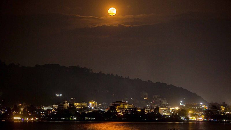(191114) -- POKHARA, Nov. 14, 2019 (Xinhua) -- The moon rises above the Fewa Lake in Pokhara city, Nepal, on Nov. 13, 2019. Pokhara is one of the most popular tourist destinations in Nepal. (Photo by Sulav Shrestha/Xinhua)