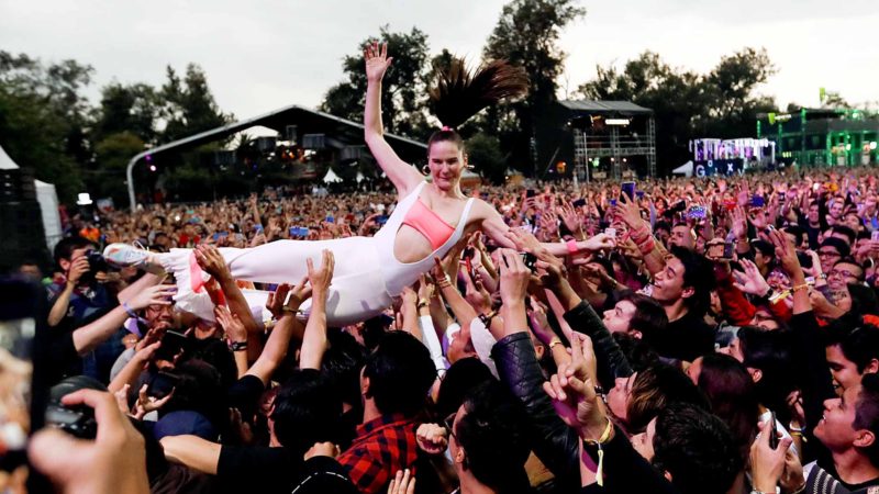 Sophie Hawley-Weld, of German-American musical duo Sofi Tukker, crowd surfs with fans during the Corona Capital music festival in Mexico City, Sunday, Nov. 17, 2019. (AP Photo/Eduardo Verdugo)
