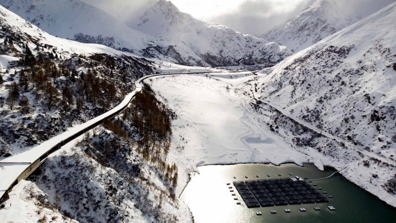 Floating barges with solar panels are pictured on the "Lac des Toules", an alpine reservoir lake, next to snow covered mountains, in Bourg-Saint-Pierre, Switzerland, Monday, November 18, 2019. The floating solar panel station consist of 36 floating barges featuring 2'240 square meters of solar cells targeting to deliver 800'000 kilowatt-hour per year, the annual power consumption of approximately 220 homes. (Laurent Darbellay/Keystone via AP)