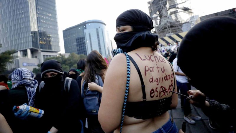 A woman has a slogan painted in her back during a march protesting violence against women in Mexico City, Monday, Nov. 25, 2019, on International Day for the Elimination of Violence against Women. In 2018 there were 3,662 gender-related killings of women in Mexico, according to the federal government. (AP Photo/Rebecca Blackwell)