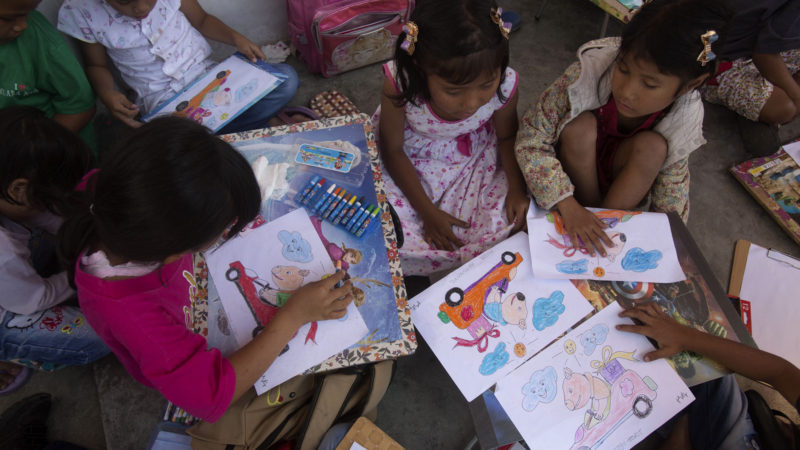 Children take part in a pig sketch coloring competition during Toba Pig and Pork Festival, in Muara, North Sumatra, Indonesia. Christian residents in Muslim-majority Indonesia's remote Lake Toba region have launched a new festival celebrating pigs that they say is a response to efforts to promote halal tourism in the area. The festival features competitions in barbecuing, pig calling and pig catching as well as live music and other entertainment that organizers say are parts of the culture of the community that lives in the area. AP Photo/RSS
