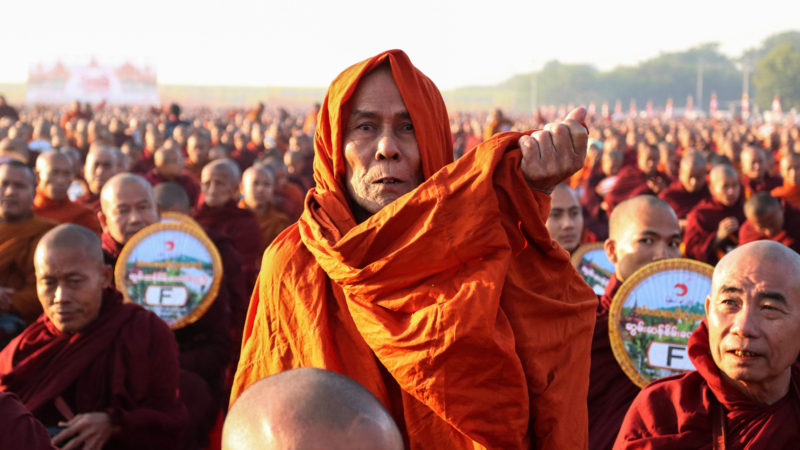 Monks line up for alms during the alms-giving ceremony to 30,000 monks organize by the region government of Mandalay affiliated with Dhammakaya Foundation at Chanmyathazi Airport in Mandalay on December 8, 2019. - Thirty-thousand monks assembled in the early morning chill of Mandalay for a spectacular alms-giving event involving a controversial mega-temple under scrutiny across the border in Thailand. Photo/RSS