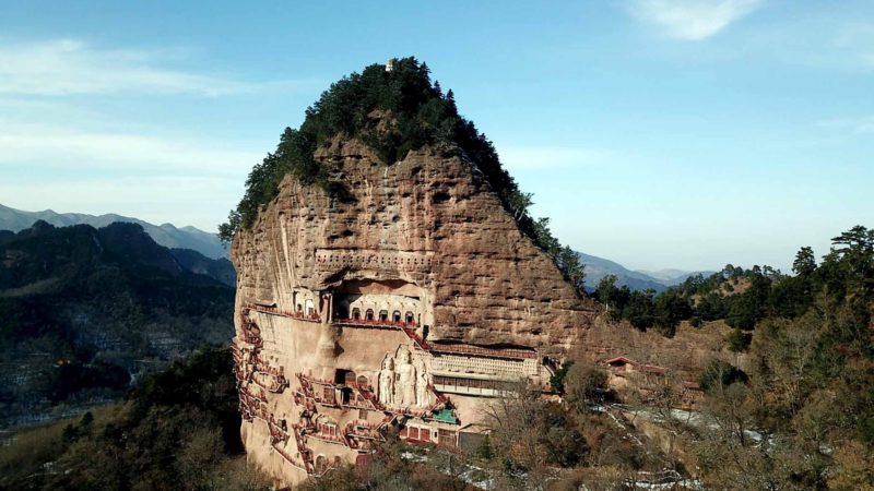 (191227) -- BEIJING, Dec. 27, 2019 (Xinhua) -- Aerial photo taken on Dec. 26, 2019 shows the Maiji Mountain Grottoes after snow in Tianshui, northwest China's Gansu Province. The Maiji Mountain Grottoes is one of the four most famous grottoes in China with 221 grottoes preserved at present. (Xinhua/Ma Ning)