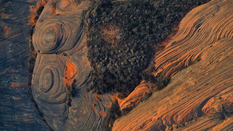 (191217) -- YAN'AN, Dec. 17, 2019 (Xinhua) -- Aerial photo taken on Dec. 16, 2019 shows a view of Danxia landform, a landscape characterized by reddish sandstone features, in Xinghe Town of Zhidan County, northwest China's Shaanxi Province. (Xinhua/Tao Ming)