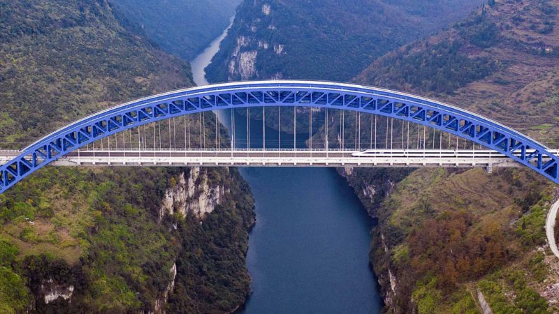 (191204) -- BEIJING, Dec. 4, 2019 (Xinhua) -- Aerial photo taken on Dec. 2, 2019 shows a train running past the bridge over Yachi River during a trial operation of Chengdu-Guiyang railway in southwest China's Guizhou Province. The 650-kilometer railway is an important part of the country's high-speed rail network consisting of eight main north-south lines and eight main east-west lines, with a design speed of 250 kilometers per hour. (Xinhua/Liu Xu)