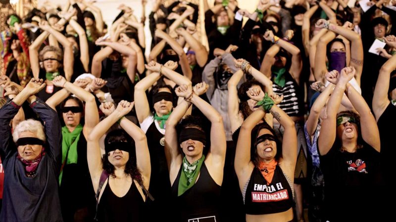 Women perform the choreography, “Un violador en tu camino” or "A rapist in your path,"  in a demonstration against gender-based violence,  at Cinelandia Square, in Rio de Janeiro, Brazil, Tuesday, Dec. 3, 2019. Blindfolded women chant the words that include: "The fault wasn't mine, nor where I was, nor how I was dressed. You were the rapist, you are the rapist," originated by the Chilean feminist collective Las Tesis which has become a global mantra for women against gender violence. (AP Photo/Silvia Izquierdo)