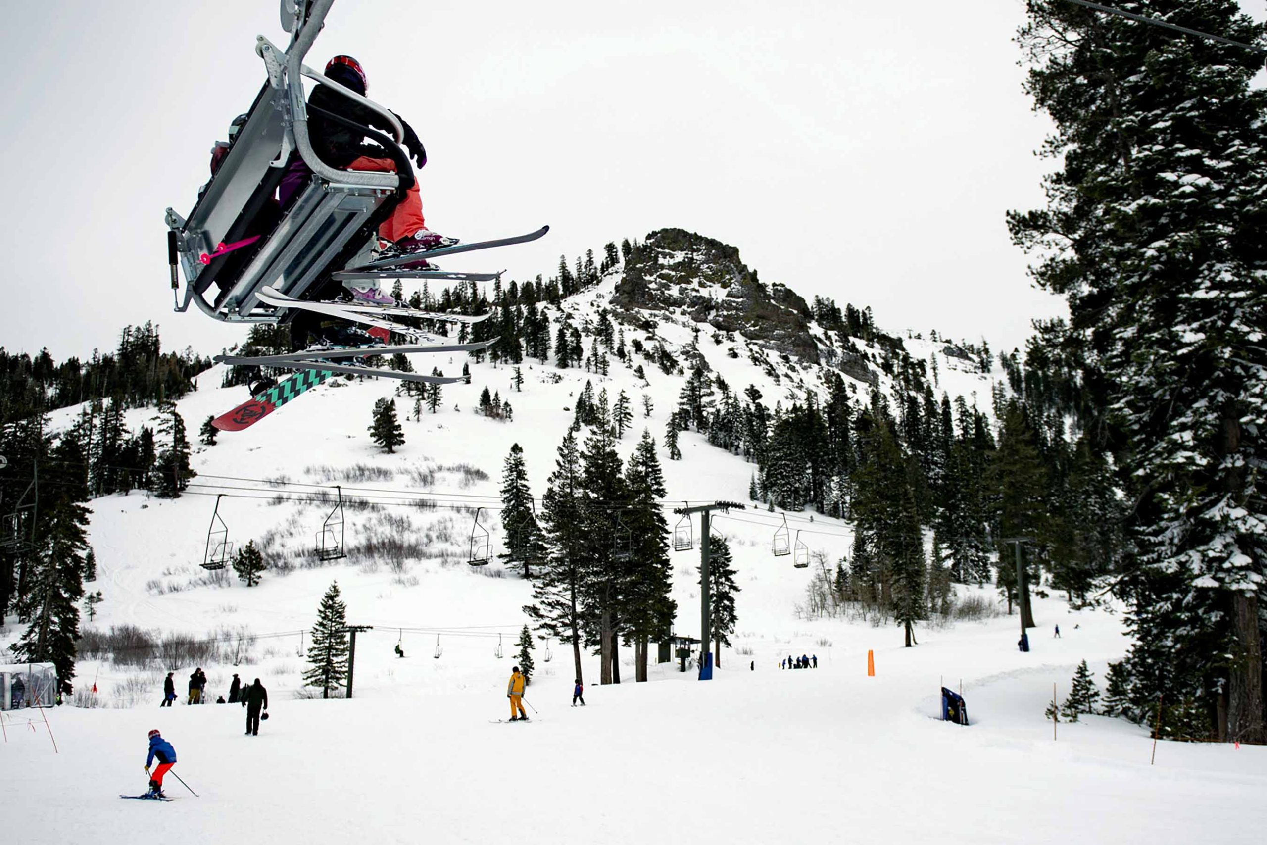 Skiers ride a chairlift at Alpine Meadows Ski Resort on Friday, Jan. 17, 2020, in front of the mountain traversed by the Subway Cirque ski run where one person was killed and another seriously injured in an avalanche earlier in the day. (Jason Pierce/The Sacramento Bee via AP)