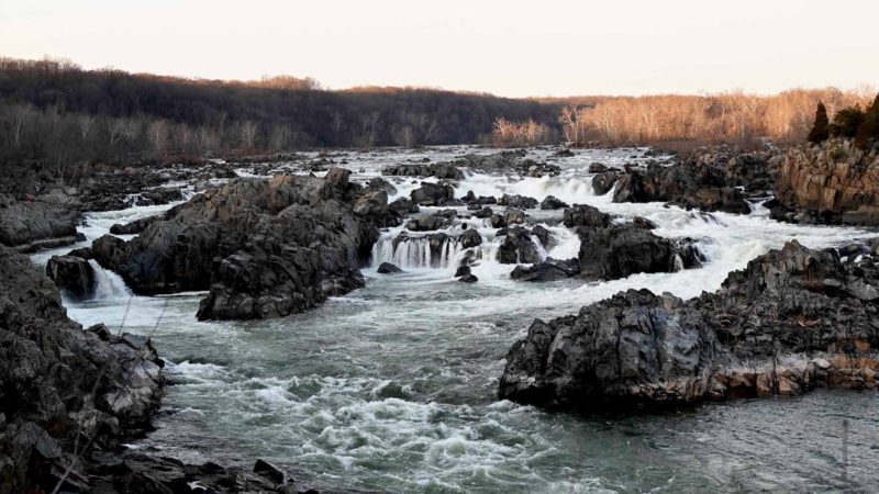 The Potomac River flows over jagged rocks and cliffs through Great Falls Park, Virginia, December 28, 2019. - The Great Falls of the Potomac River are the remains of the Patowmack Canal, founded by George Washington, the first canal in the United States that used locks to raise and lower boats. A one-mile (1.6 km) bypass canal that began operating in 1785 gave small barges the opportunity to skirt around the falls and to distribute manufactured goods upstream and raw materials downstream. (Photo by EVA HAMBACH / AFP)