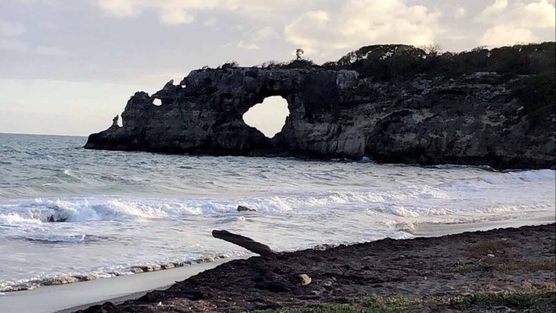This Jan. 27, 2019 photo courtesy of Edgar Gracia shows "Punta Ventana," or Window Point, in Guayanilla, Puerto Rico. The bridge on the top of the hole collapsed during an earthquake on Monday, Jan. 6, 2020. (Edgar Gracia Portello via AP)