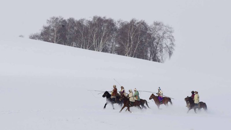  BEIJING-- People take part in a performance during a photography festival themed on the horse culture on grassland at Bashang Pasture in Chifeng City, north China's Inner Mongolia Autonomous Region, Jan. 6, 2020. The 3rd photography festival featuring horse-themed performances opened on Monday and will last till Jan. 8. (Photo by Li Zhipeng/Xinhua)
