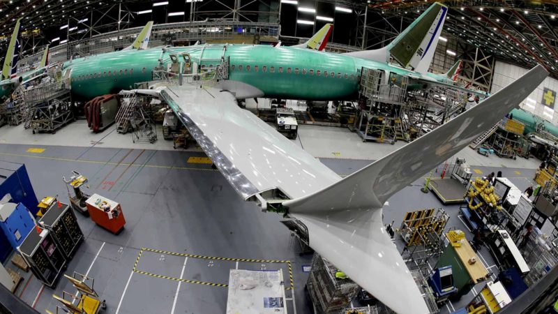 FILE - In this March 27, 2019, photo taken with a fish-eye lens, a Boeing 737 MAX 8 airplane sits on the assembly line during a brief media tour in Boeing's 737 assembly facility in Renton, Wash. The looming production shutdown of Boeing 737 Max jets is taking a toll on a key supplier. Spirit AeroSystems Holdings Inc. is asking employees if they will take voluntarily buyouts. Spirit suspended production of fuselages and other parts for the Max on Jan. 1, 2020, after Boeing told the Wichita, Kansas, company to suspend shipments. (AP Photo/Ted S. Warren)