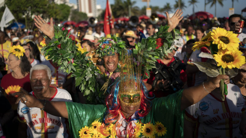 Revelers take part in the "Banda de Ipanema" street party in Rio de Janeiro, Brazil, Saturday, Feb. 8, 2020. Thousands have started attending the popular street parties, two weeks ahead of the world's famous carnival festival that begins on Feb 21. (AP Photo/Leo Correa)